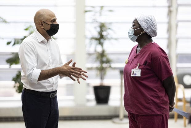 Secretary of State for Health and Social Care Sajid Javid in conversation with an NHS staff member at Guys and St Thomas Hospital